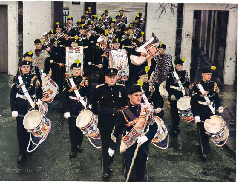 Front Row L/R Cpl George Winterbottom, L/Cpl Alex Dovey, Fus. Harry Edwards, L/Cpl Peter Lewis 'Twitch' 2nd row Titch Nuttal, The bass drum left is Reg Mayfield Bass drummer on the right is Ronnie Hart. Brian Gilmore Band Master Tony Richards Drummy Robinson