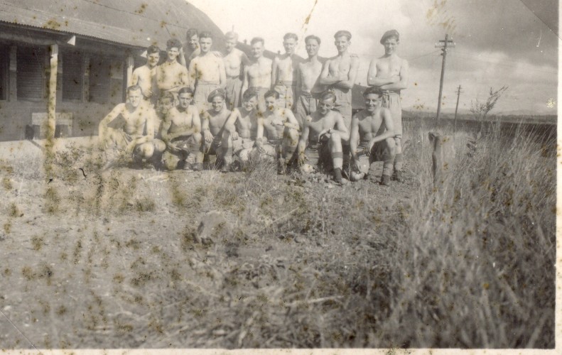 Jack Bibby standing, far left. Somewhere quite hot